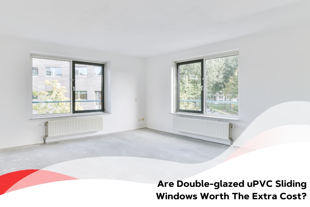 Empty room with two large double glazed sliding windows, showcasing the benefits of uPVC frames and energy efficiency.