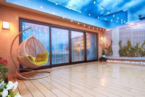 Outdoor patio with large uPVC sliding doors with curtains, showcasing the benefits of an energy-efficient sliding door setup.