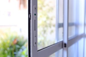 Close-up of a double-glazed sliding window, showcasing the locking mechanism and energy-efficient design.