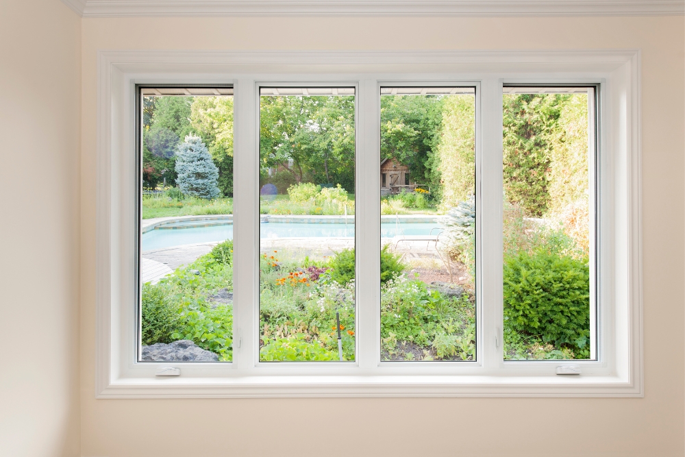 View through a uPVC casement window showcasing a lush garden and a swimming pool, highlighting casement window benefits.