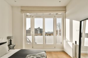 Bedroom with uPVC French doors leading to a balcony, highlighting secure locks and modern design for French door security.