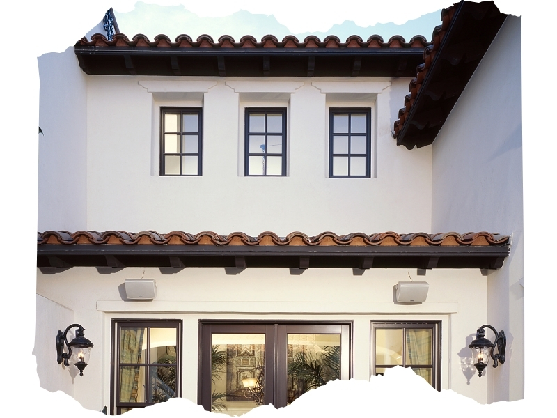 Mediterranean-style home featuring elegant French window design with terracotta roof tiles.