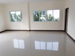 Empty room with tiled floor and multiple sliding windows, highlighting sliding window installation cost considerations for large spaces.