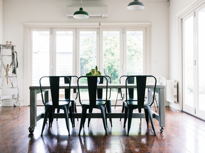 Dining room installing bifold doors with large windows and industrial style furniture.