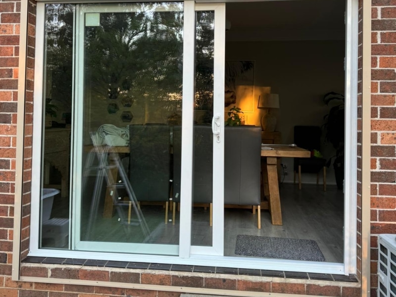 Sliding uPVC door on a brick home, demonstrating secure framing and the advantages of uPVC windows and doors.